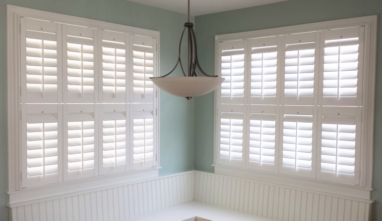 Pastel green wall in Fort Myers kitchen with shutters.